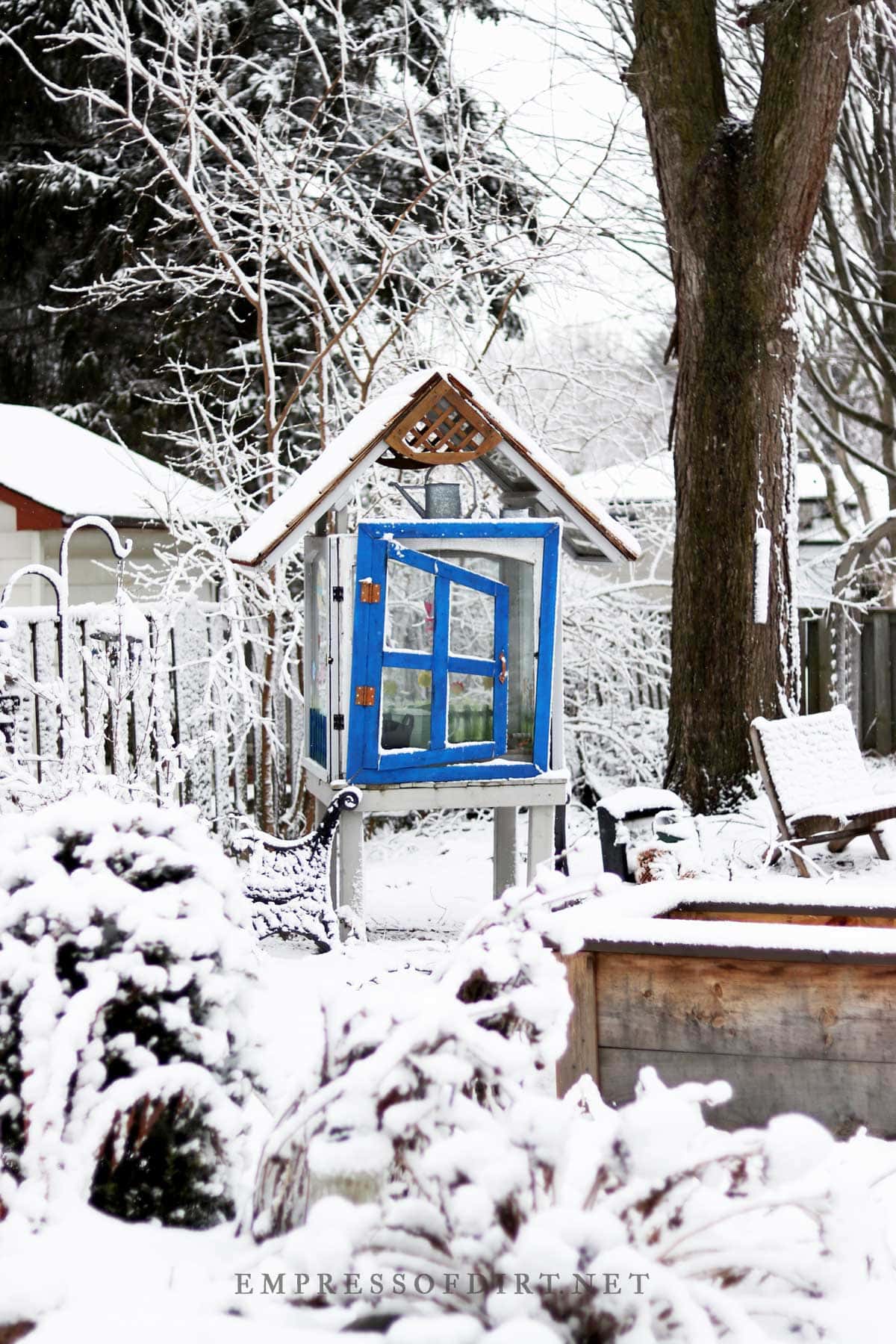 Blue-framed optical illusion mirror in the winter garden.