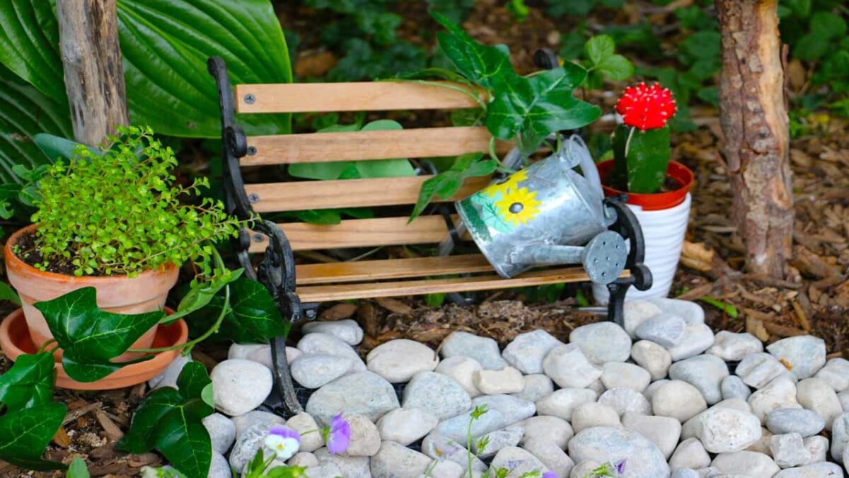 Miniature fairy garden fountain in a watering can