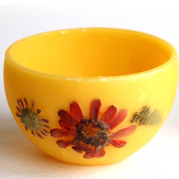 Bowl made from beeswax and decorated with pressed flowers.