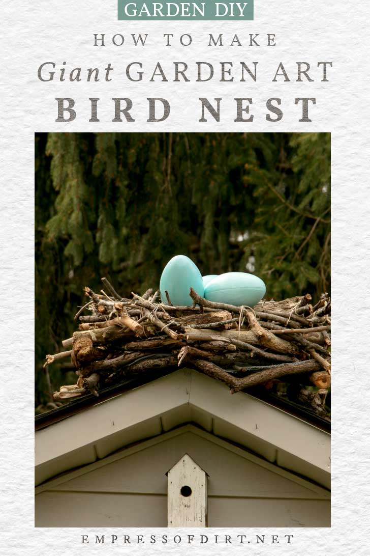 Giant decorative bird nest made from branches with blue eggs inside.