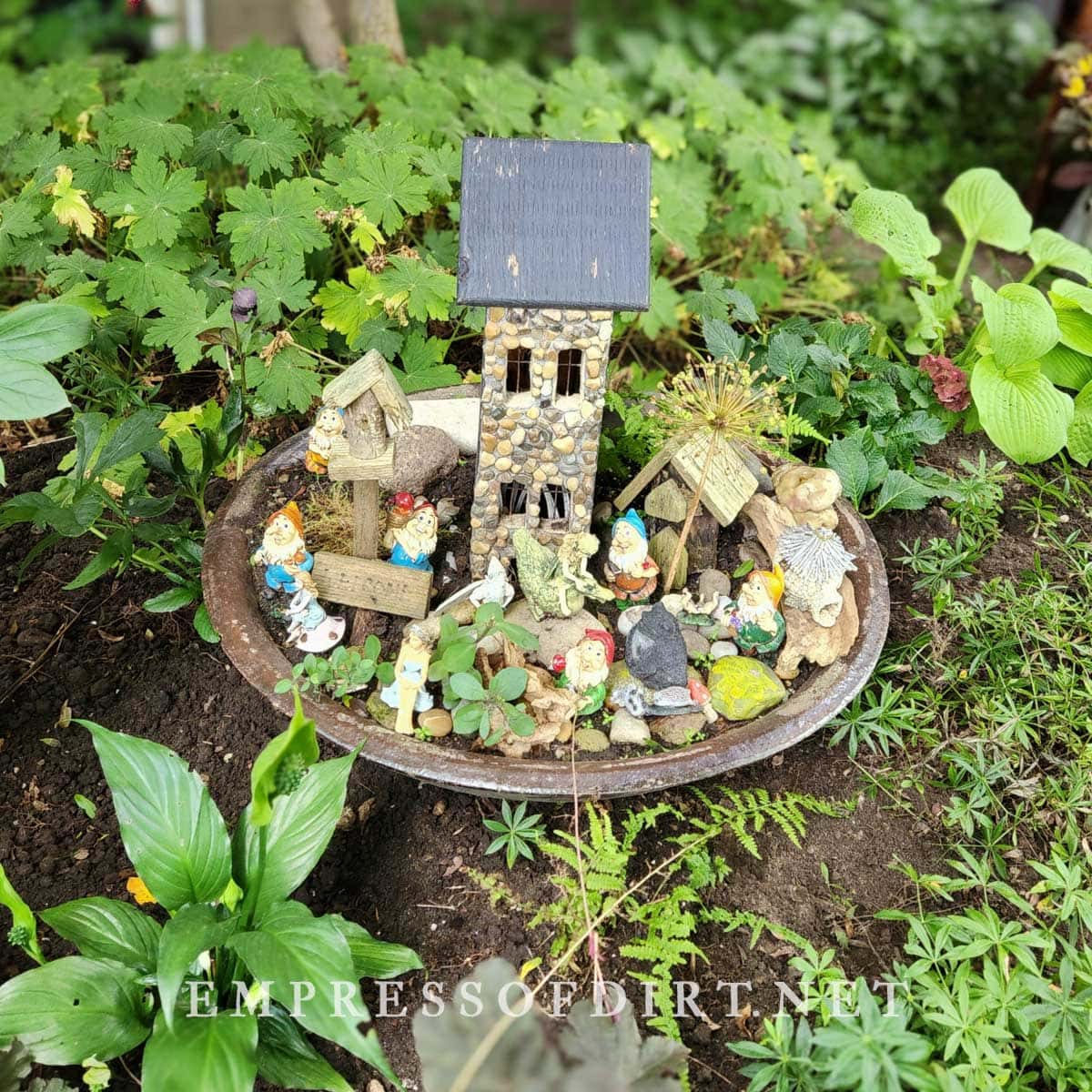 Old birdbath with fairy house