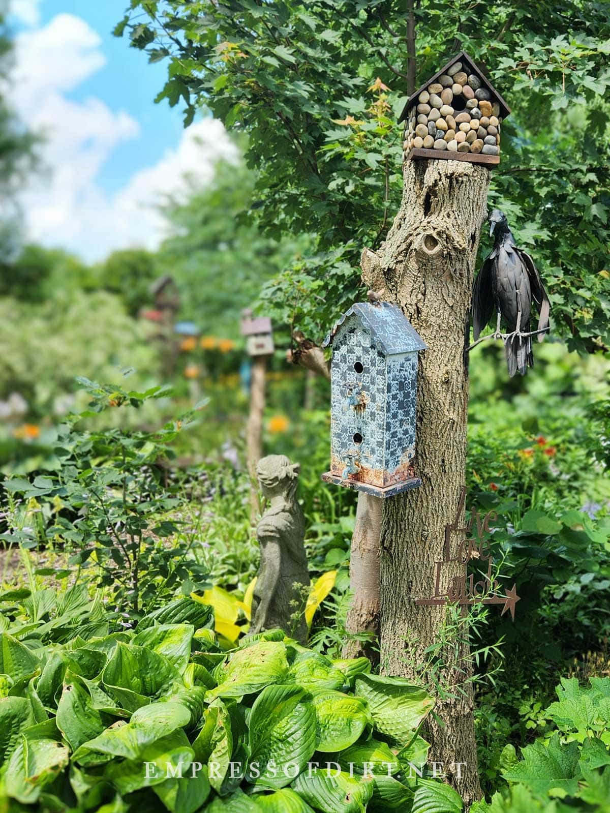 Colorful birdhouse on tree stump