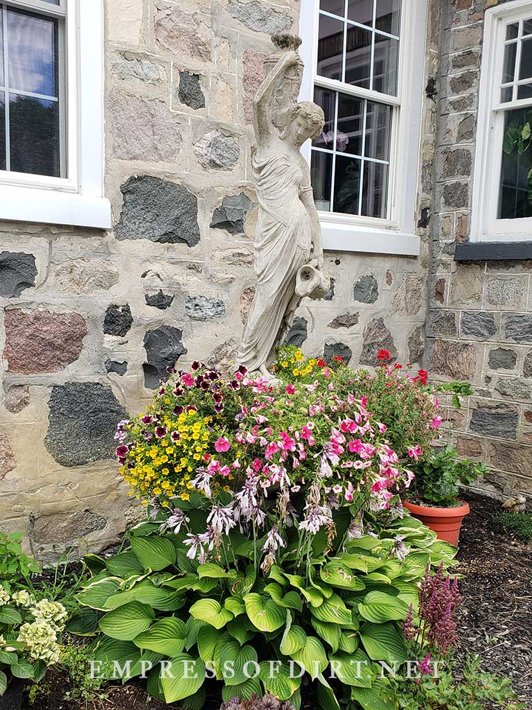 Woman statue in flower garden