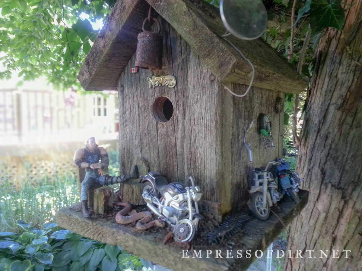 Decorative wood birdhouse with motorcycle toy collection