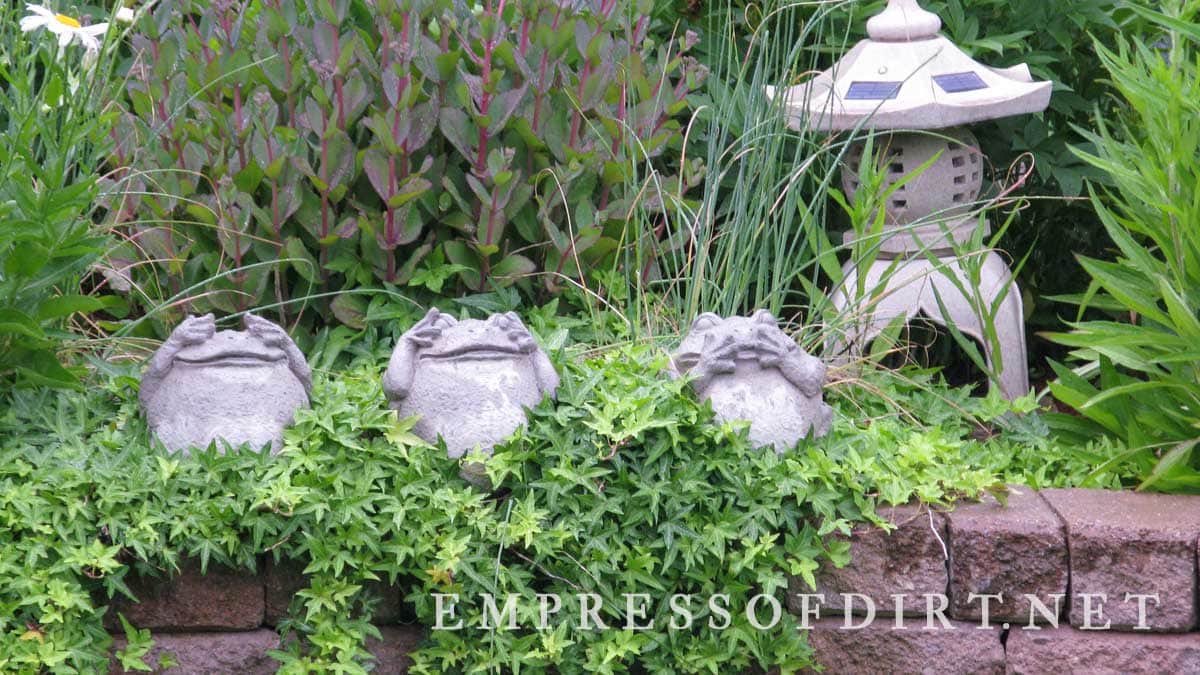 Row of frog garden art