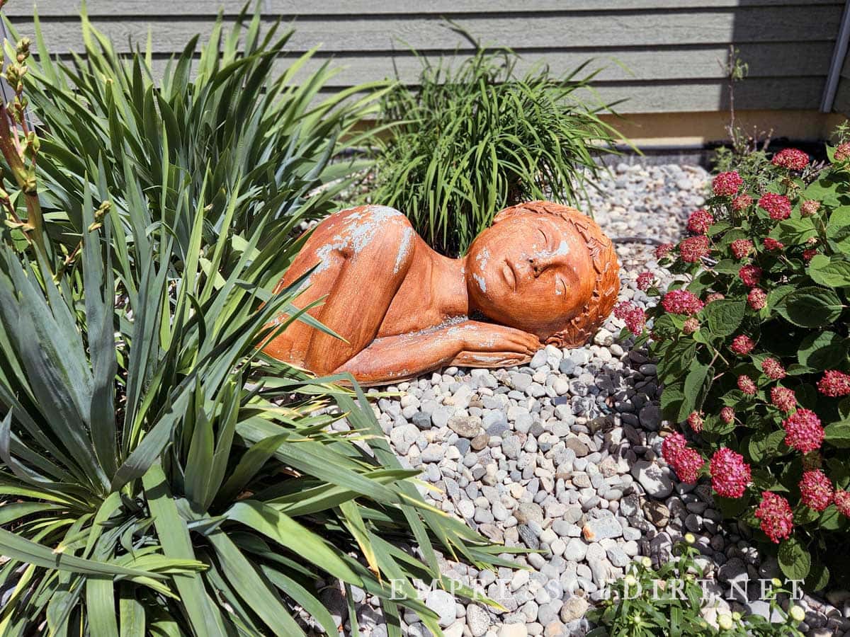 Carving of sleeping woman in garden
