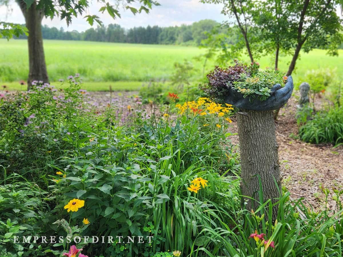 Tree stump with flower pot on top