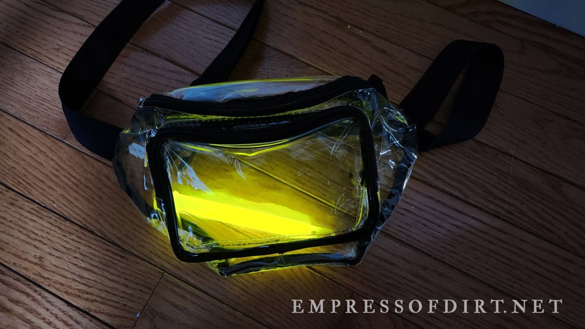 A clear fanny pack holds the firefly costume glow sticks