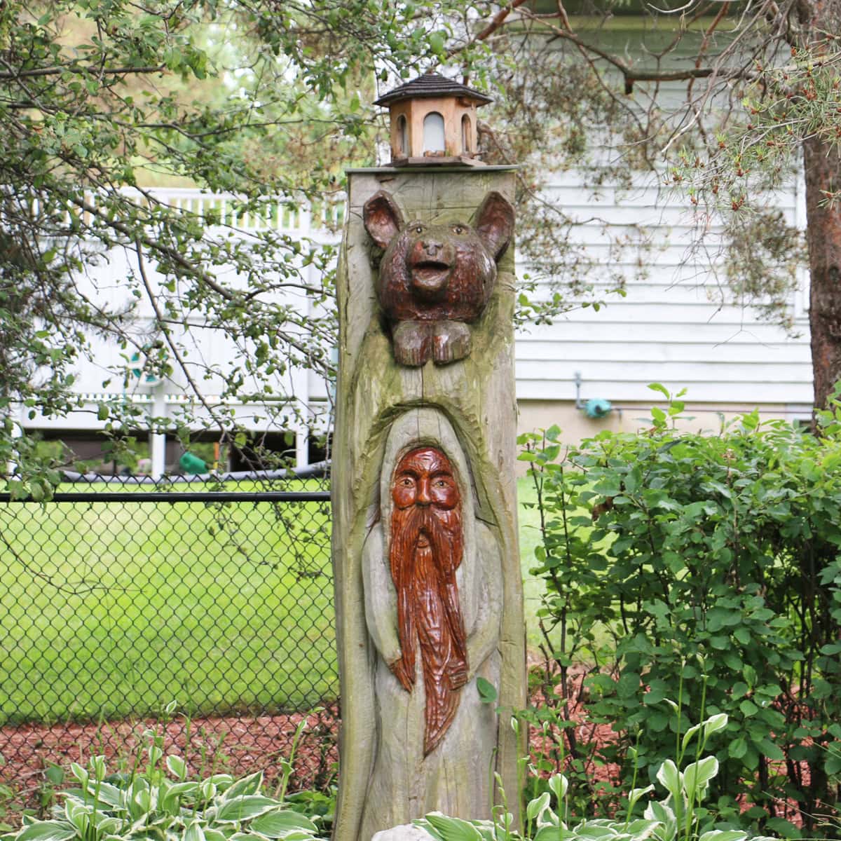 Tree stump with carvings.