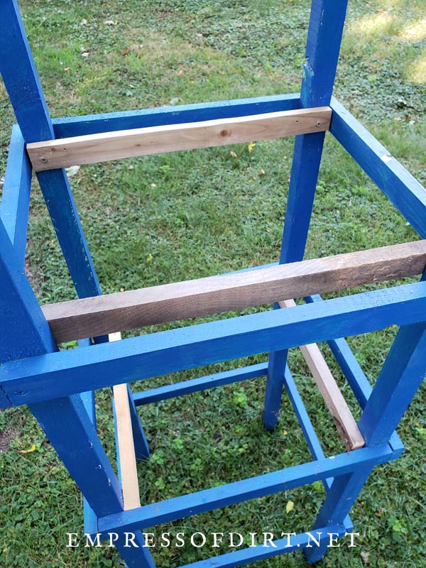 Inner support rails on wooden tomato cage.